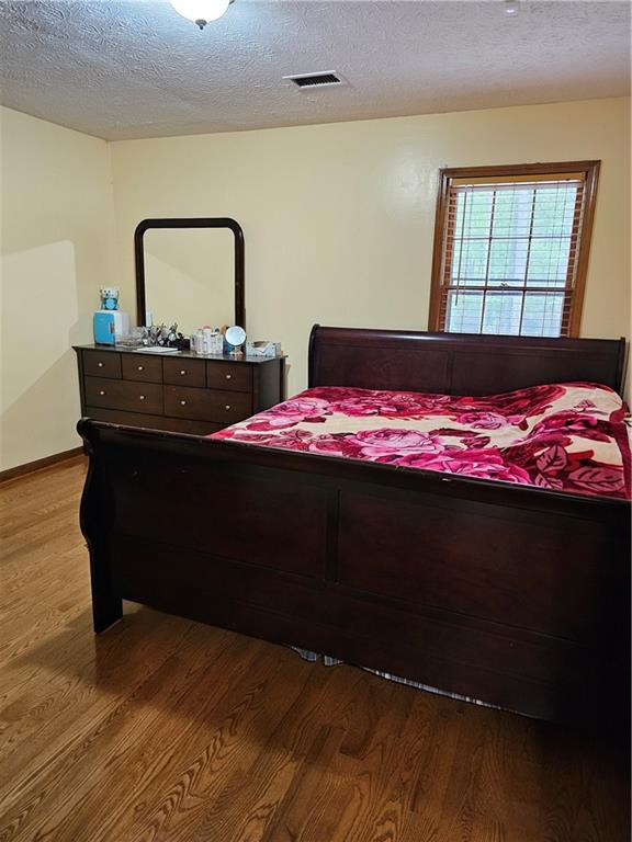 1935 Coventry Way Jonesboro, GA 30236 - Photo 30 of 33 a bedroom with a bed and a dresser