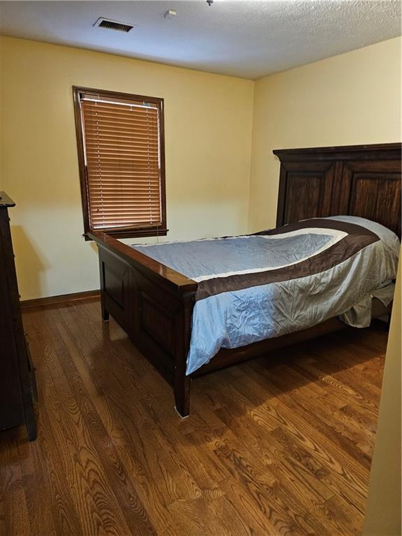 1935 Coventry Way Jonesboro, GA 30236 - Photo 31 of 33 a bedroom with a bed and wooden floor