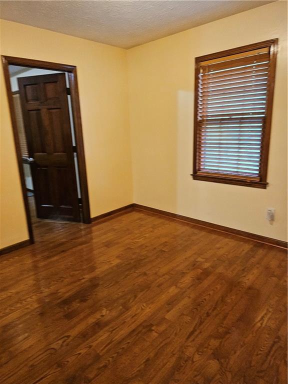 1935 Coventry Way Jonesboro, GA 30236 - Photo 32 of 33 a view of an empty room with wooden floor and a window