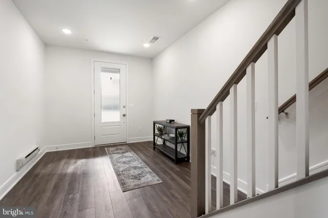 a view of an entryway with wooden floor and stairs