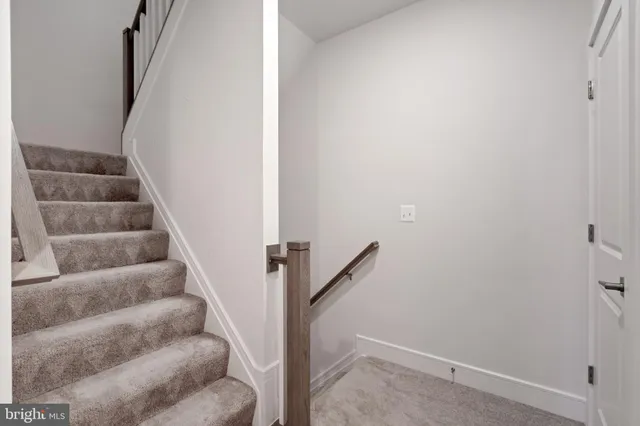 a view of staircase with white walls