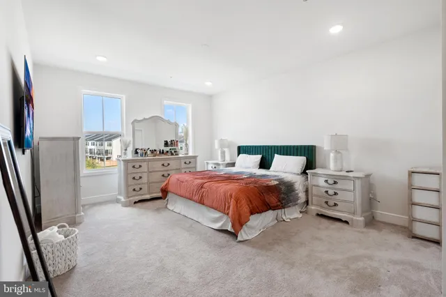 a bedroom with a bed and a view of kitchen