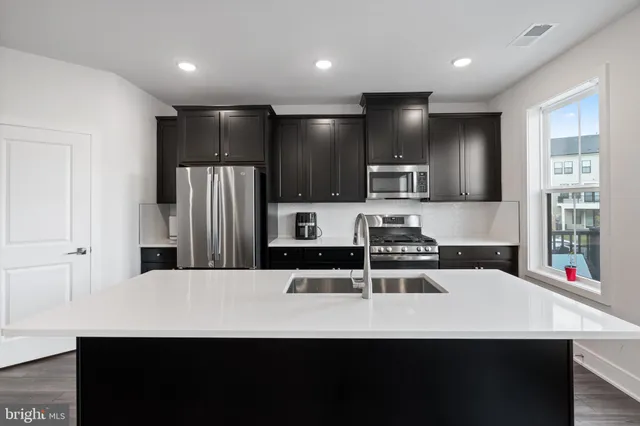 a kitchen with stainless steel appliances a refrigerator and a sink