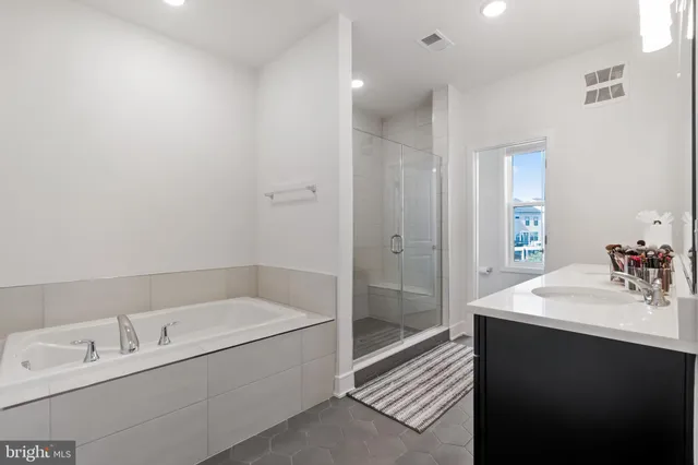 a bathroom with a bathtub and a sink