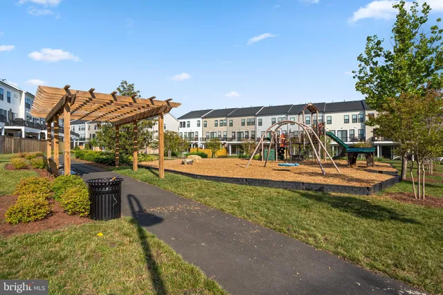 a view of a swimming pool with a patio and a yard