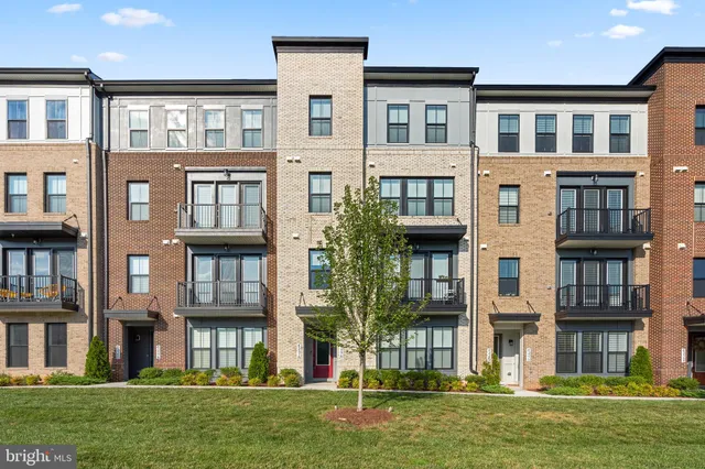 a front view of a residential apartment building with a yard