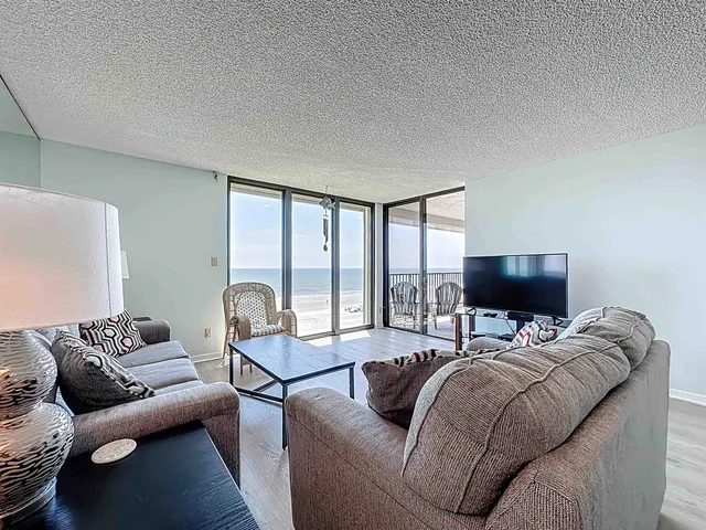 a bedroom with furniture and a flat screen tv