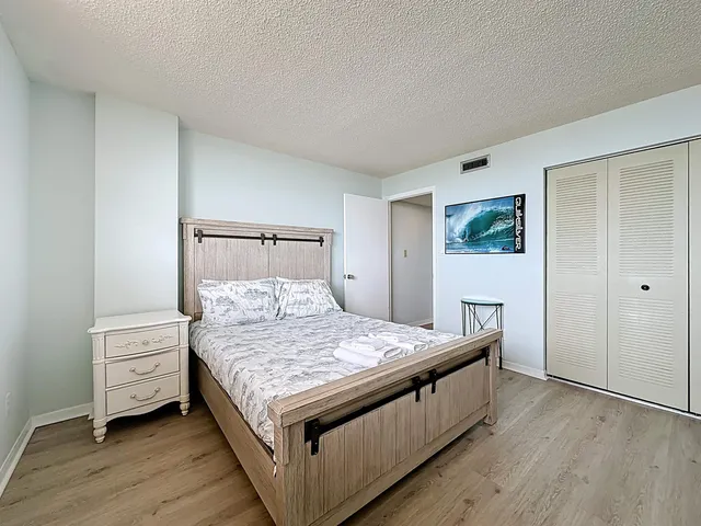 a bedroom with a bed and a dresser