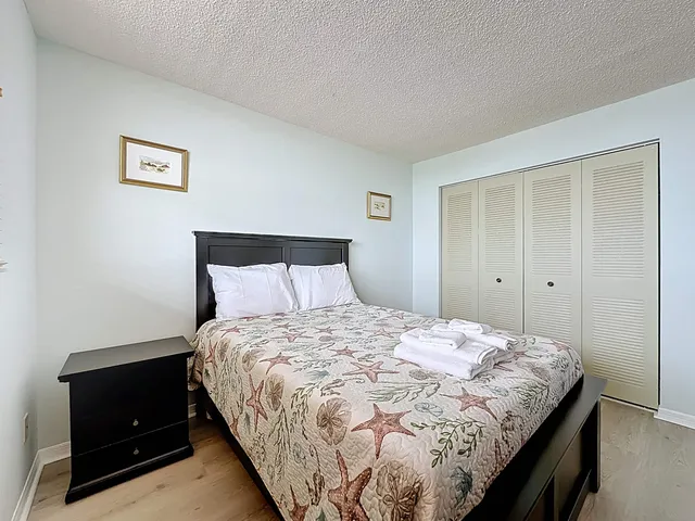 a bedroom with a bed and a night stand