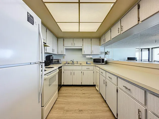 a kitchen with cabinets a sink and appliances