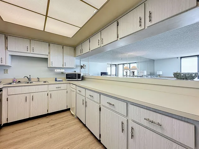 a kitchen with cabinets a sink and appliances