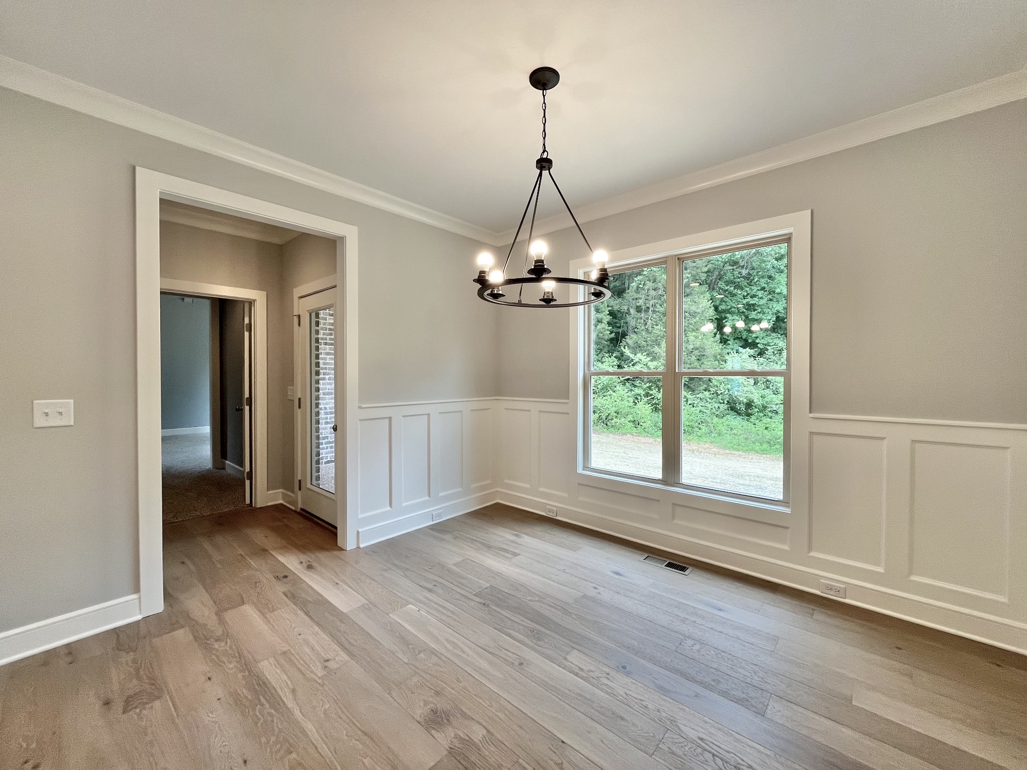 808 Ridgestone Place, Unit 105C Lebanon, TN 37087 - Photo 11 of 25 an empty room with wooden floor chandelier and windows