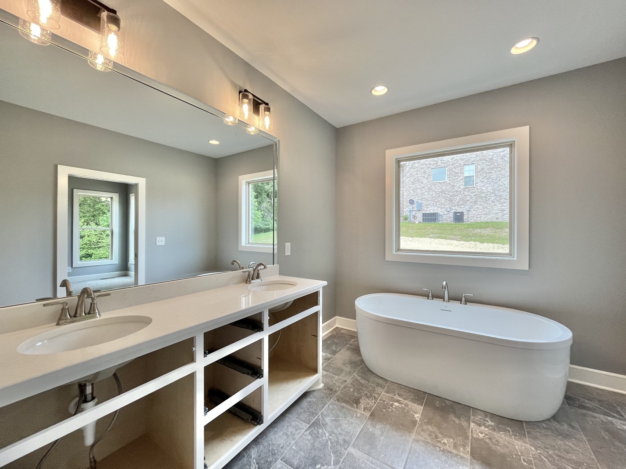808 Ridgestone Place, Unit 105C Lebanon, TN 37087 - Photo 19 of 25 a spacious bathroom with a double vanity sink and a mirror