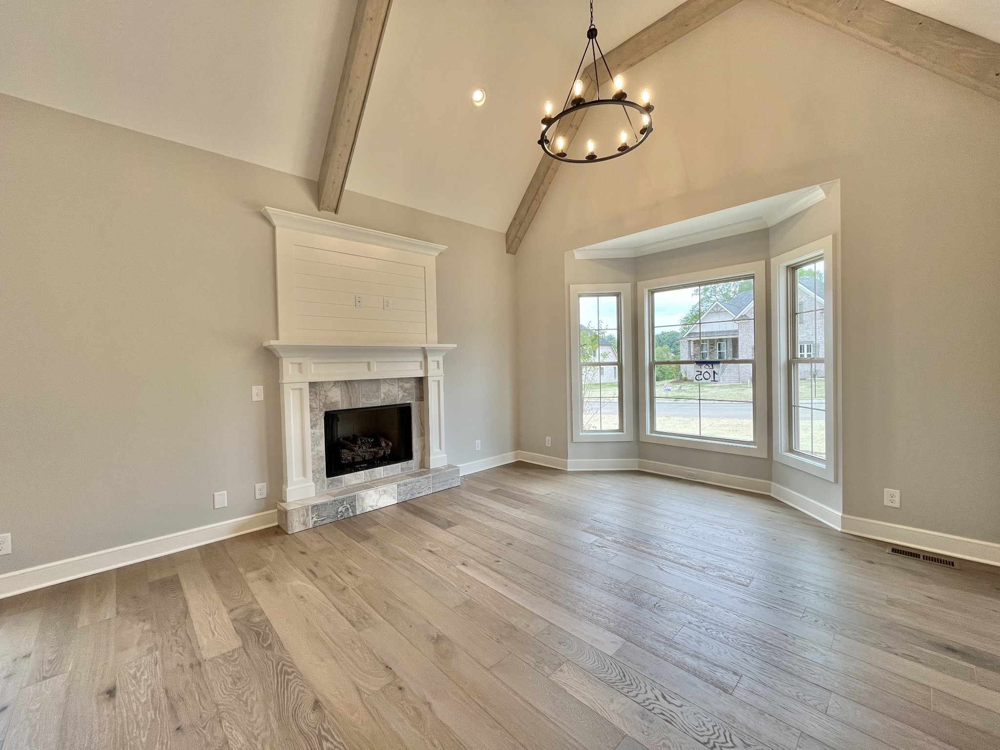 808 Ridgestone Place, Unit 105C Lebanon, TN 37087 - Photo 7 of 25 a view of an empty room with wooden floor fireplace and a window