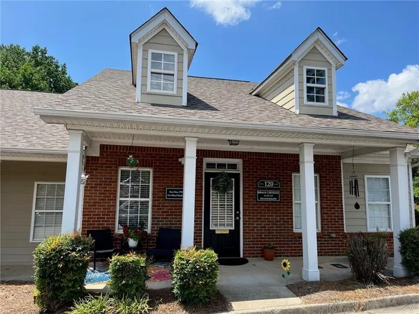 front view of a house with potted plants
