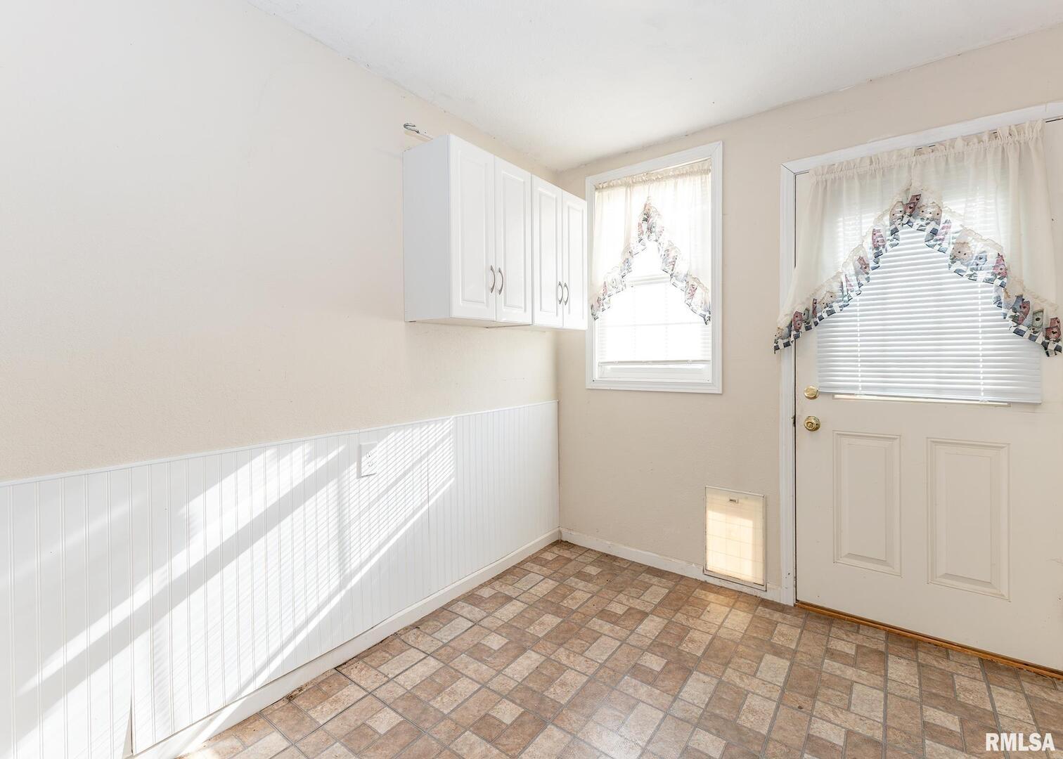 3015 North 3rd Street Clinton, IA 52732 - Photo 12 of 28 a view of a kitchen with wooden floor and entryway