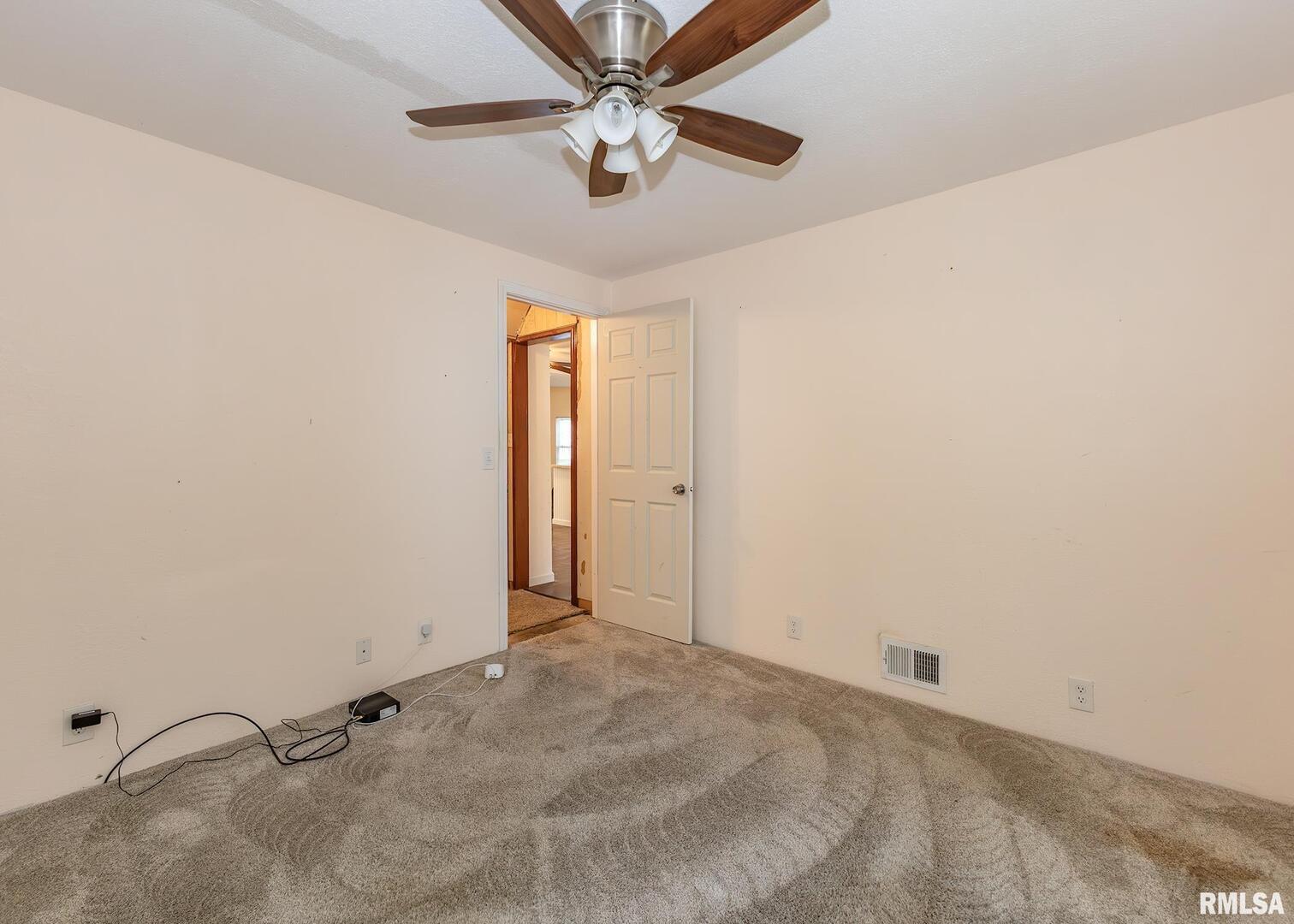 3015 North 3rd Street Clinton, IA 52732 - Photo 14 of 28 a view of a room with a ceiling fan and a window