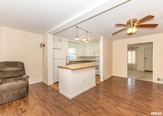 a kitchen with a refrigerator and a couch