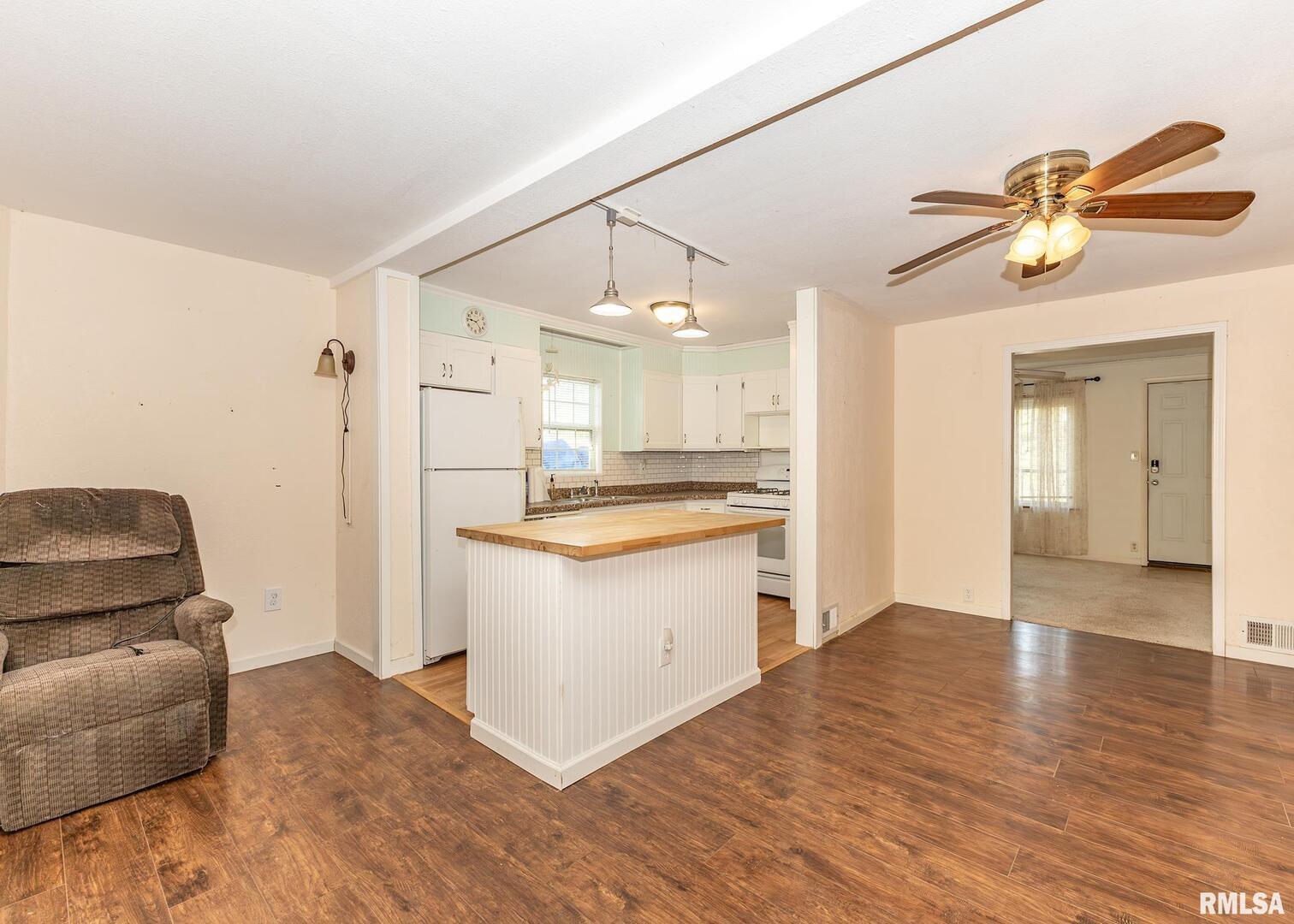 3015 North 3rd Street Clinton, IA 52732 - Photo 6 of 28 a kitchen with a refrigerator and a couch