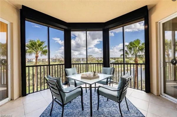a view of a porch with furniture and a yard