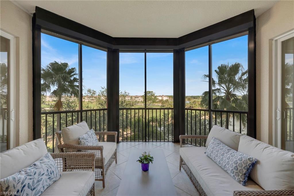 a living room with furniture and floor to ceiling window