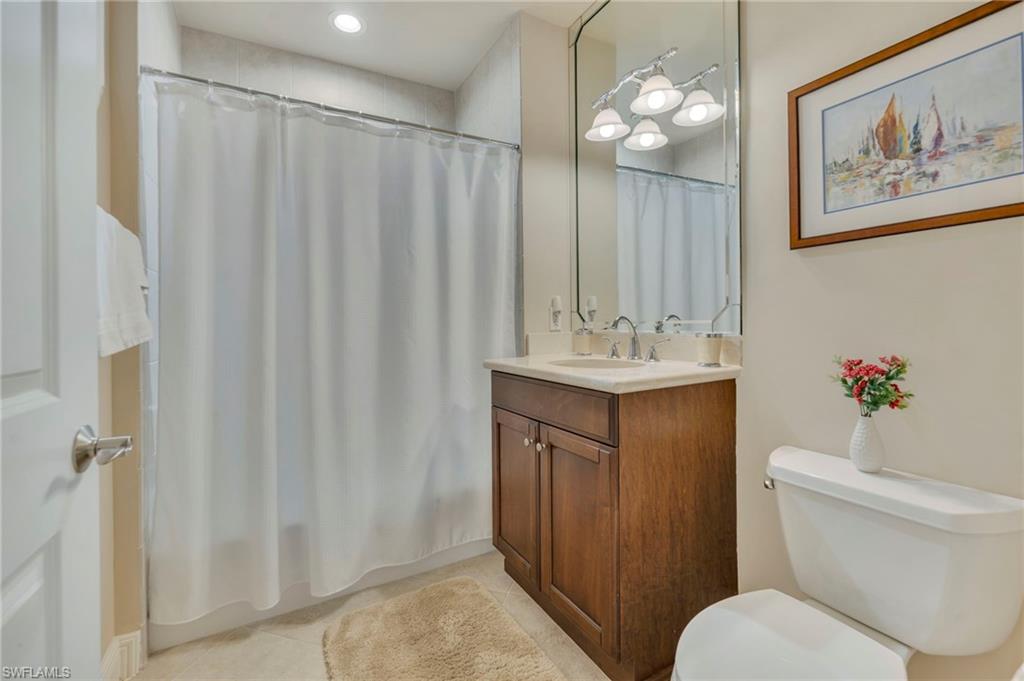 580 El Camino Real, Unit 3402 Naples, FL 34119 - Photo 14 of 35 a bathroom with a sink vanity mirror and toilet