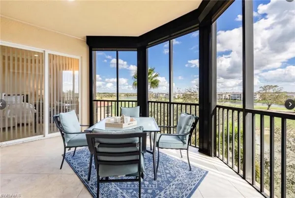 a view of a city from a balcony with furniture