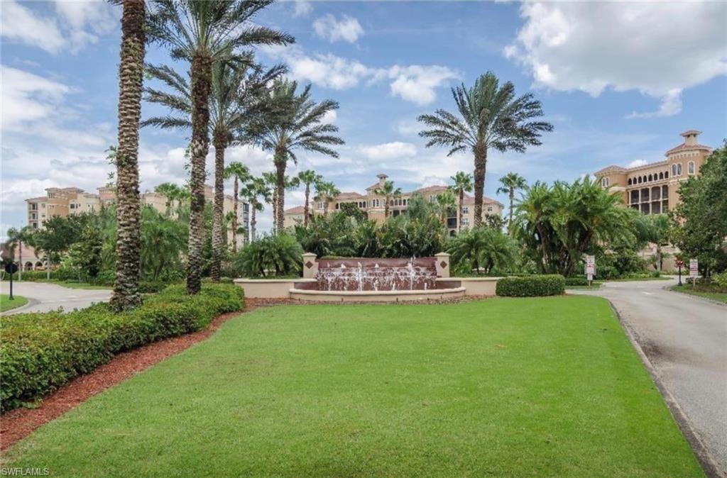 580 El Camino Real, Unit 3402 Naples, FL 34119 - Photo 16 of 35 a view of a swimming pool and trees in the background