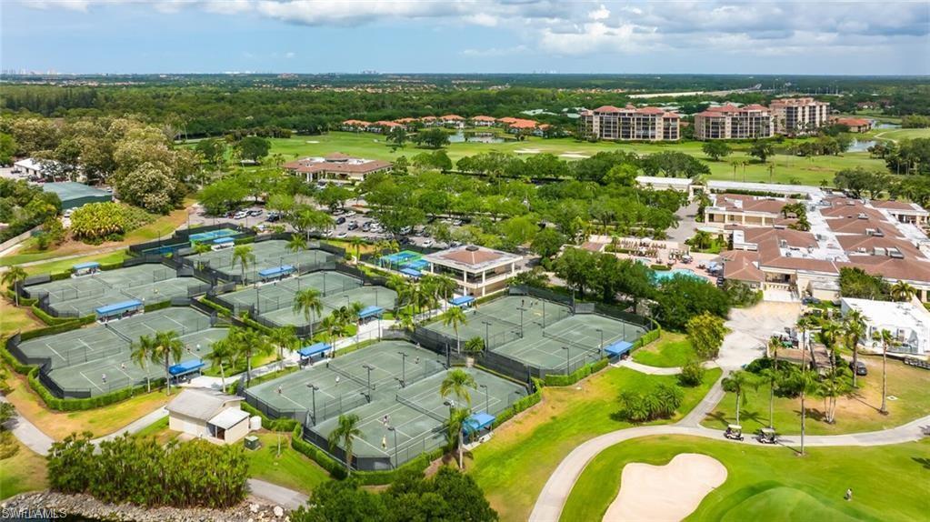 580 El Camino Real, Unit 3402 Naples, FL 34119 - Photo 19 of 35 an aerial view of residential houses with outdoor space and trees