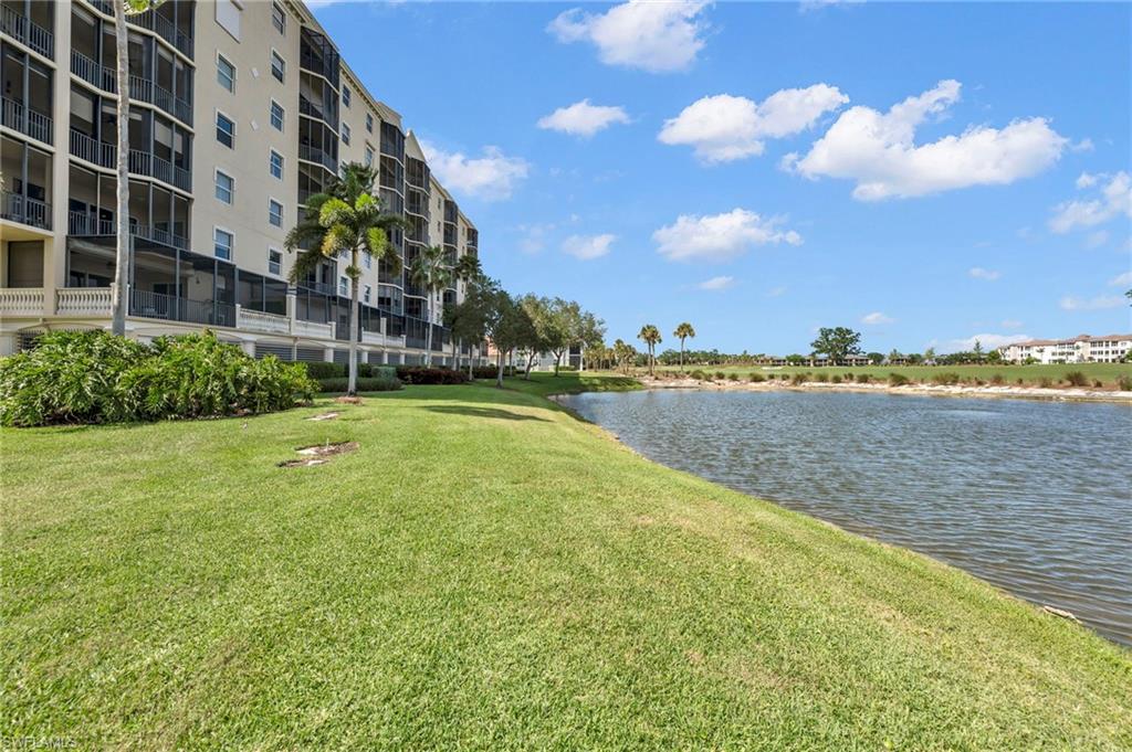 580 El Camino Real, Unit 3402 Naples, FL 34119 - Photo 2 of 35 a view of a building with lake and trees in the background