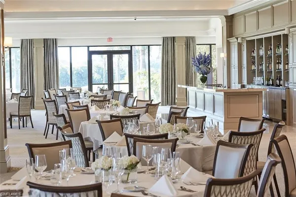 a view of a dining room with furniture large windows and wooden floor