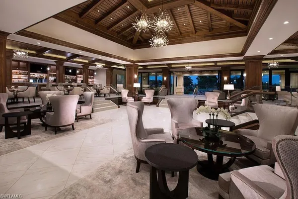 a room with lots of furniture and chandelier