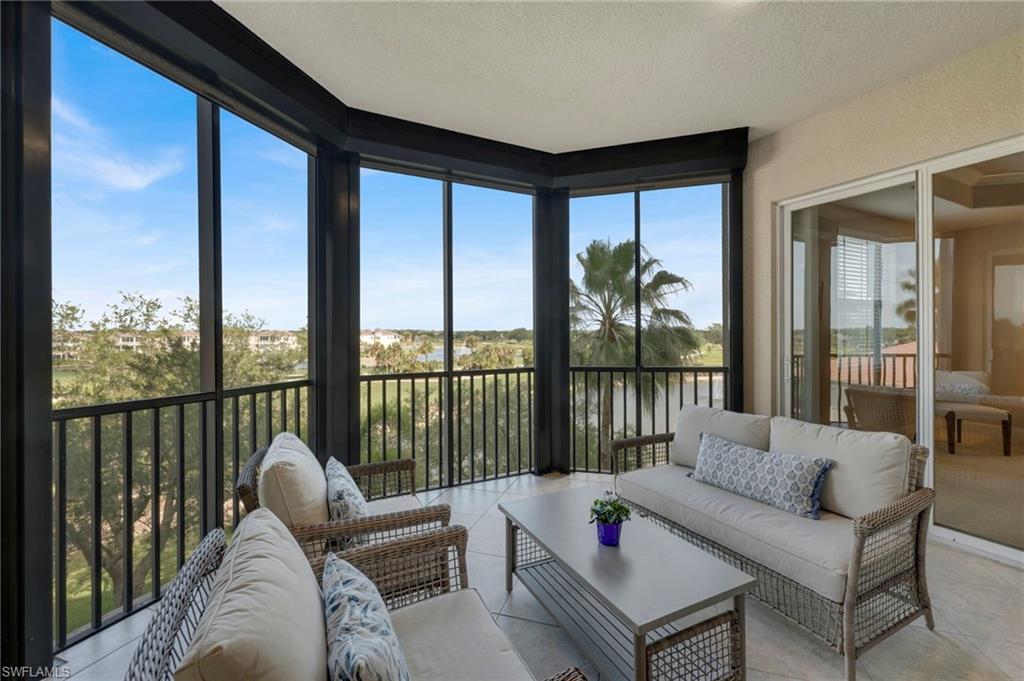 580 El Camino Real, Unit 3402 Naples, FL 34119 - Photo 3 of 35 a living room with furniture tv and a large window