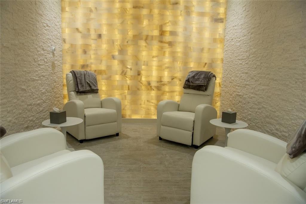 580 El Camino Real, Unit 3402 Naples, FL 34119 - Photo 31 of 35 a living room with furniture and a lamp