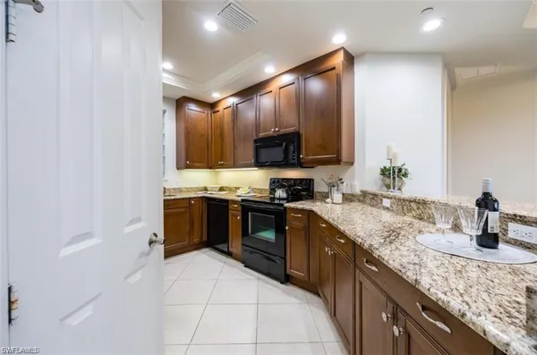a kitchen with stainless steel appliances granite countertop a sink stove and cabinets