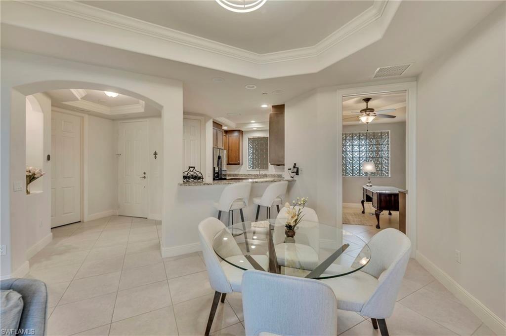 580 El Camino Real, Unit 3402 Naples, FL 34119 - Photo 6 of 35 a view of a dining room with furniture and wooden floor