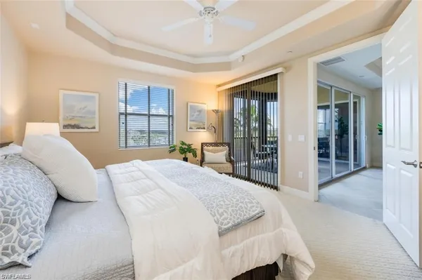 a bedroom with a large bed and a chandelier