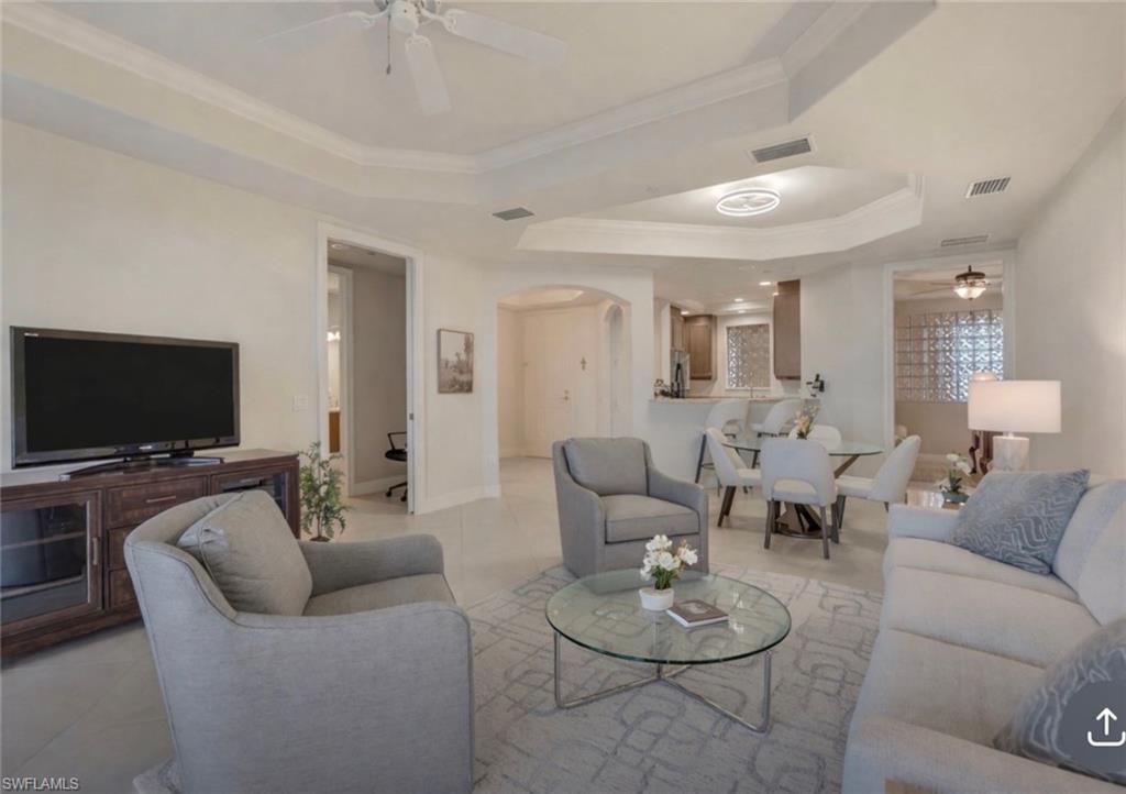 580 El Camino Real, Unit 3402 Naples, FL 34119 - Photo 9 of 35 a living room with furniture and a flat screen tv