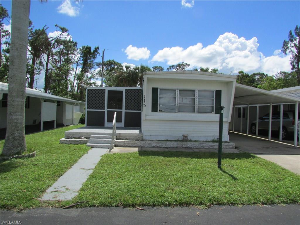 a view of a house with backyard and a tree