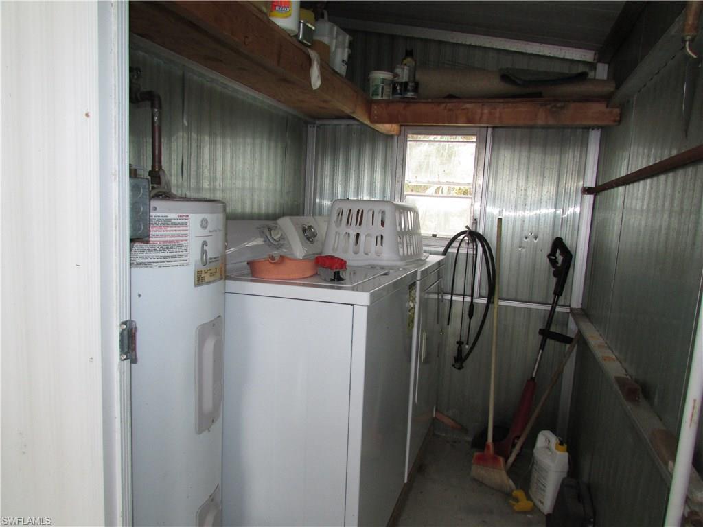 113 Enchanting Boulevard, Unit E113 Naples, FL 34112 - Photo 9 of 11 a utility room with dryer and washer