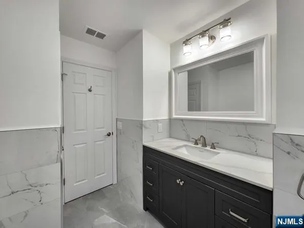 a bathroom with a double vanity sink and mirror