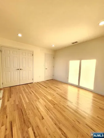 a view of an empty room and wooden floor