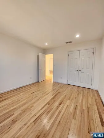 a view of an empty room and wooden floor