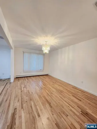 a view of an empty room and wooden floor