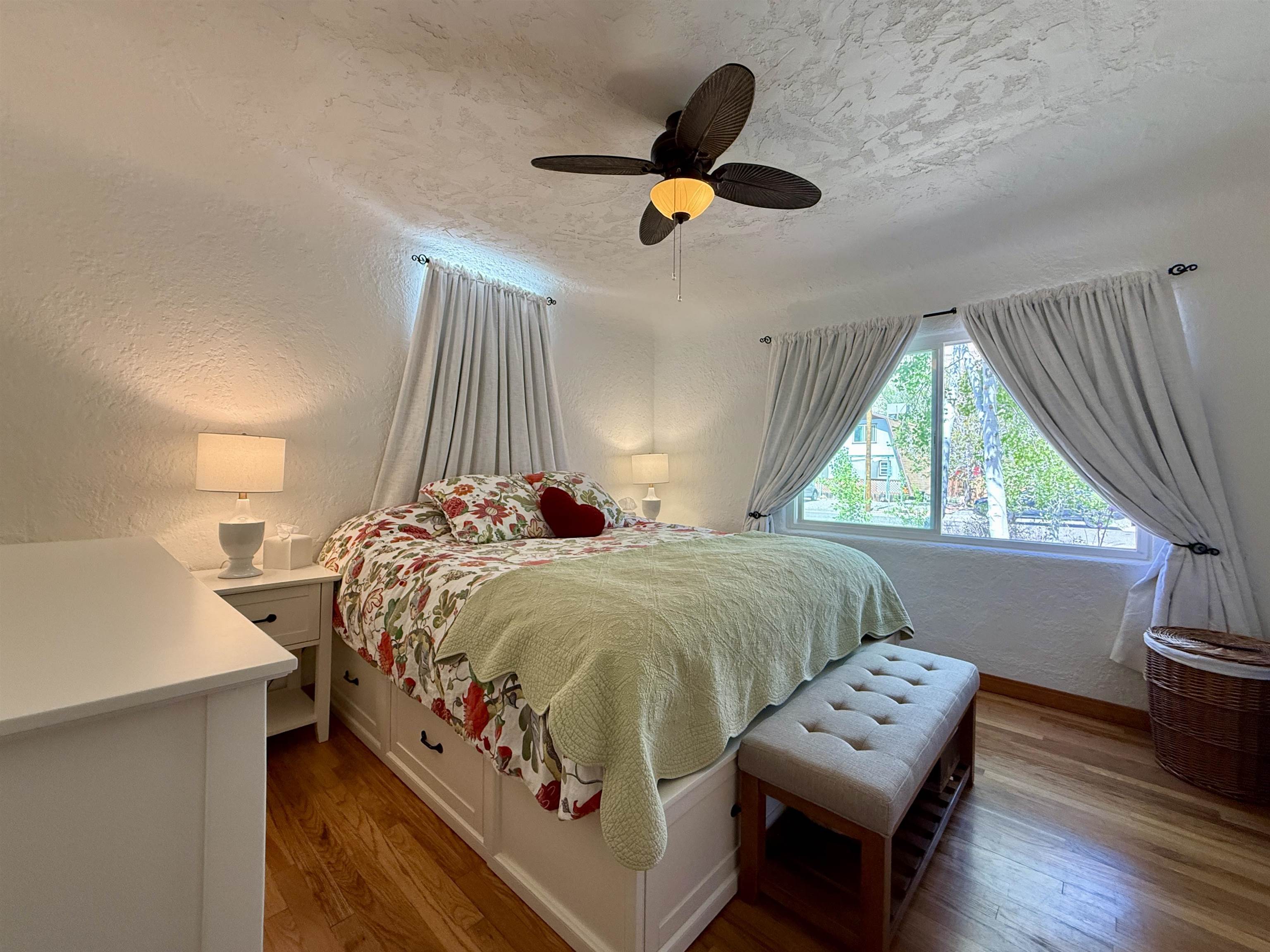 435 West 4th Street Palisade, CO 81526 - Photo 15 of 28 a bed sitting in a bedroom next to a window