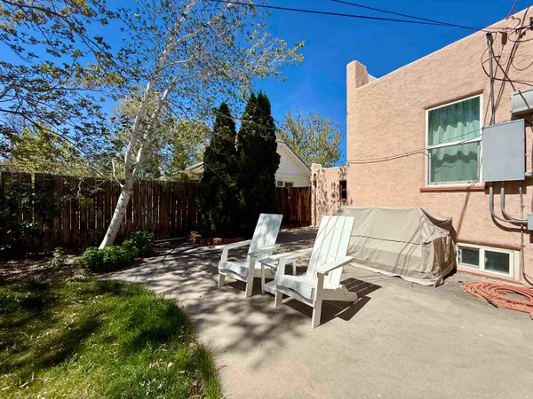 a view of backyard with a table and chairs