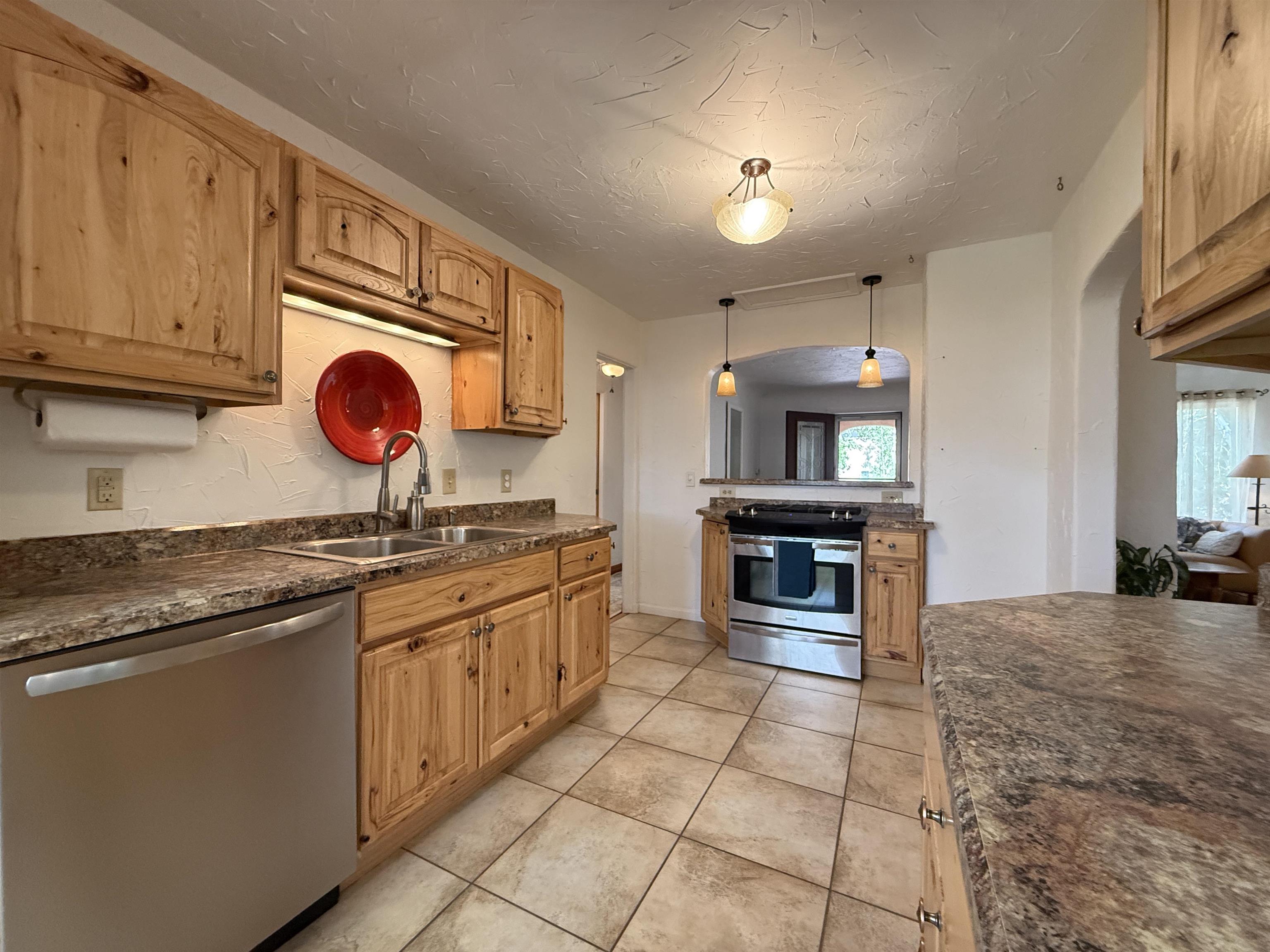 435 West 4th Street Palisade, CO 81526 - Photo 8 of 28 a kitchen with stainless steel appliances granite countertop a sink and stove top oven