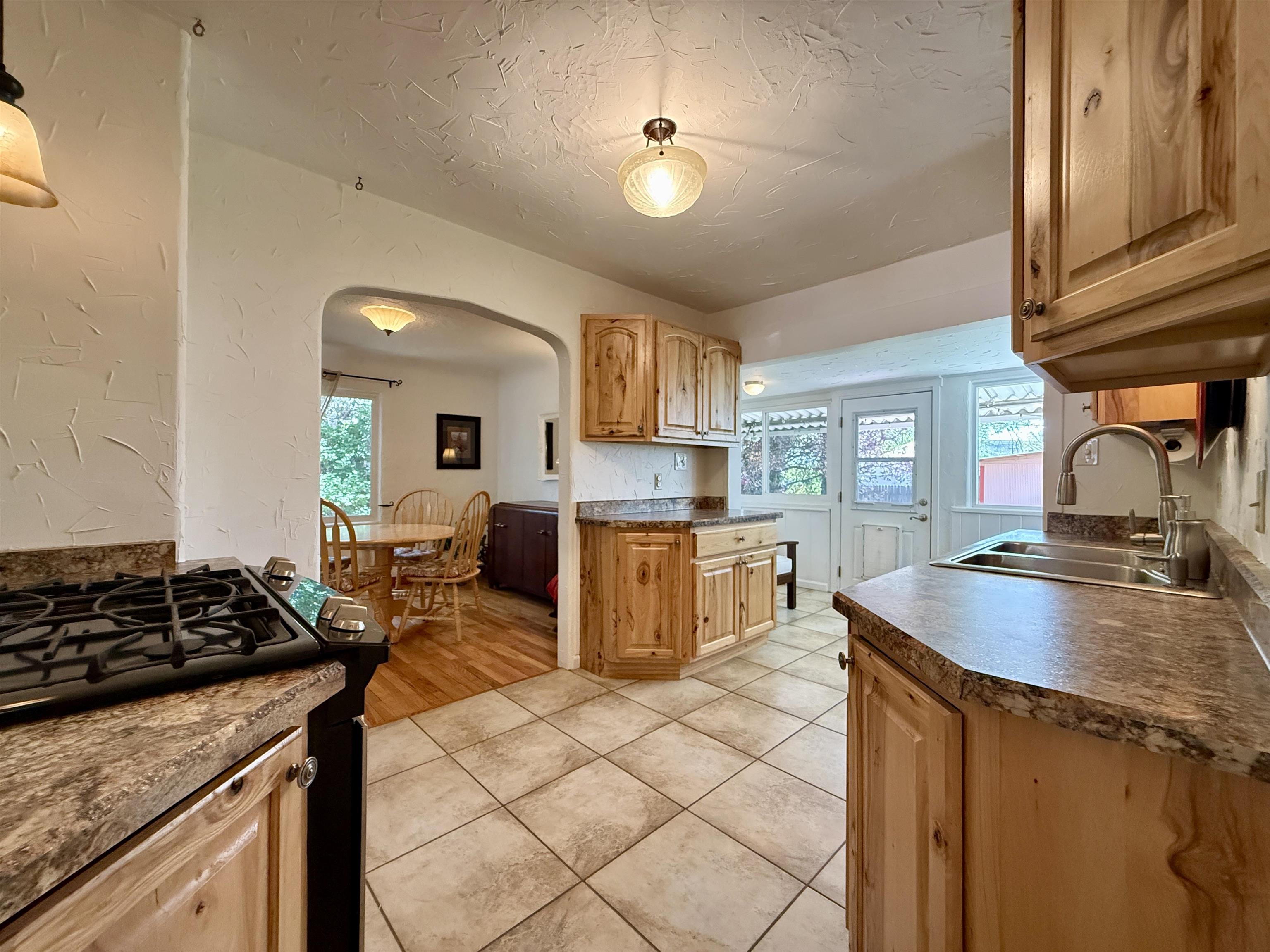 435 West 4th Street Palisade, CO 81526 - Photo 9 of 28 a kitchen with granite countertop a sink stove and cabinets