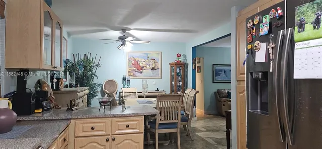 a kitchen with stainless steel appliances granite countertop a refrigerator and a sink