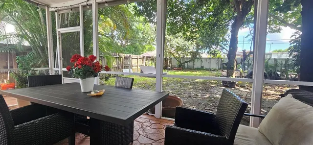 a view of a patio with table and chairs and potted plants
